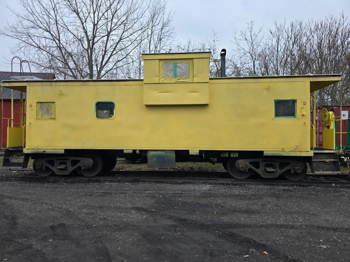 a train is parked on the side of the road